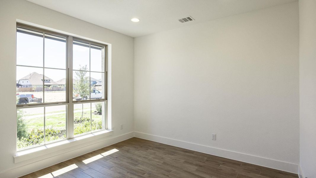 Spare room with dark wood-type flooring, a residential view, and recessed lighting Spare room with dark wood-type flooring, a residential view, and recessed lighting