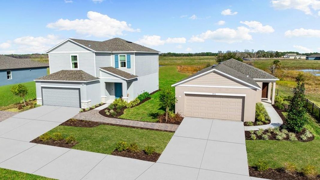 Front exterior of a new home in Coasterra Community Group Page, Palmetto, FL, highlighting curb appeal (Image 2). Front exterior of a new home in Coasterra Community Group Page, Palmetto, FL, highlighting curb appeal (Image 2).