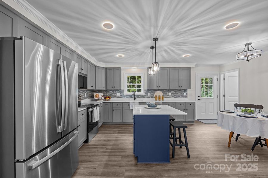 Large kitchen with recessed lighting and island.
