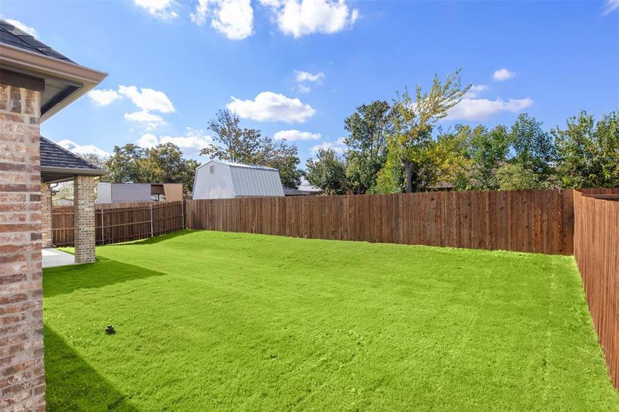 Fenced backyard with a patio