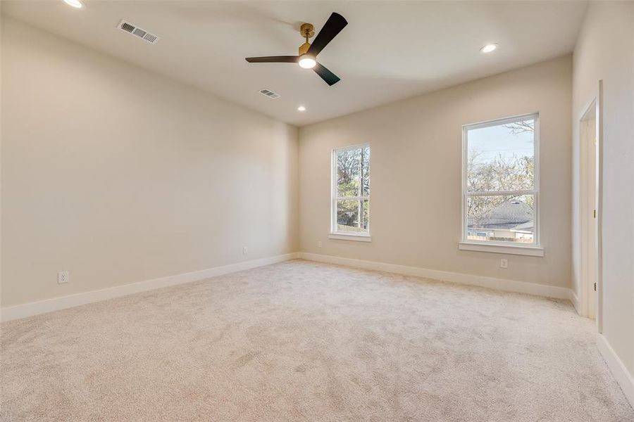 Spare room with light colored carpet, a ceiling fan, and recessed lighting Spare room with light colored carpet, a ceiling fan, and recessed lighting