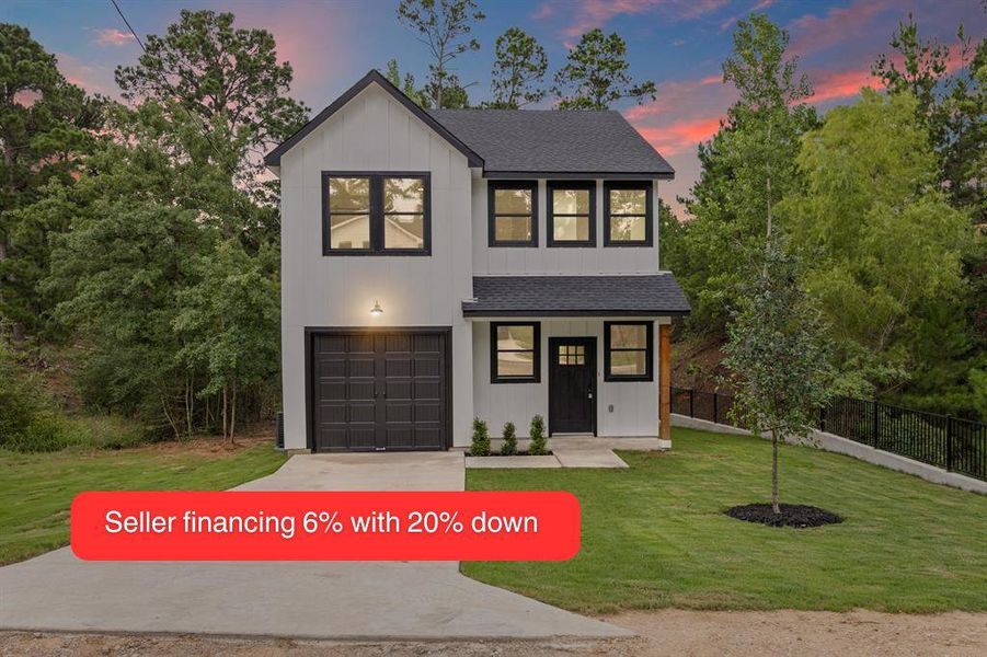 Modern inspired farmhouse with a shingled roof, a lawn, and driveway Modern inspired farmhouse with a shingled roof, a lawn, and driveway