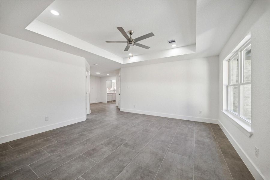 Additional view of living area leading into dining and kitchen areas.