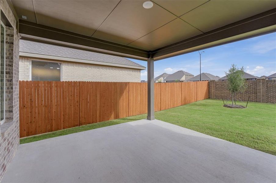 Covered patio with recessed lighting, concrete flooring, and a expansive lawn