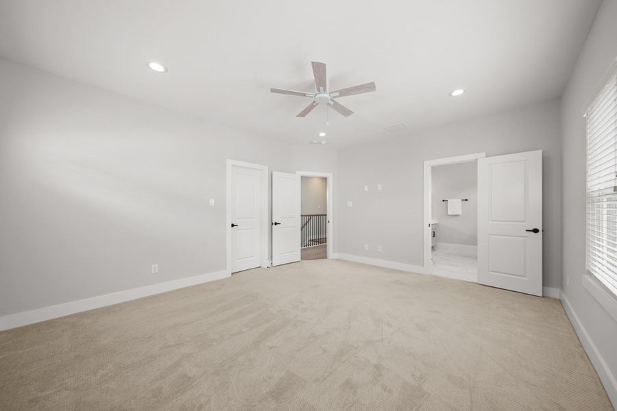 From the bedroom, one door to the right leads to the beautifully finished private bath, while the one on the left opens to a thoughtfully designed walk-in closet. From the bedroom, one door to the right leads to the beautifully finished private bath, while the one on the left opens to a thoughtfully designed walk-in closet.