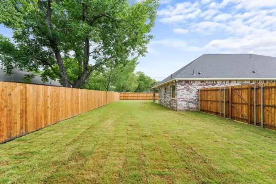 Expansive grass yard with wood privacy fencing Expansive grass yard with wood privacy fencing
