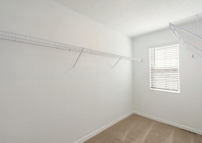 The walk in closet is spacious and ready for your wardrobe