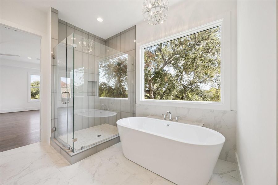 Bathe in natural light -- the soaking tub and shower enjoy natural light without sacrificing privacy. Bathe in natural light -- the soaking tub and shower enjoy natural light without sacrificing privacy.