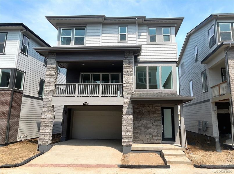 Front exterior of a home in the Vermilion Creek: The Skyline Collection community, located in Centennial, CO (Image 3).