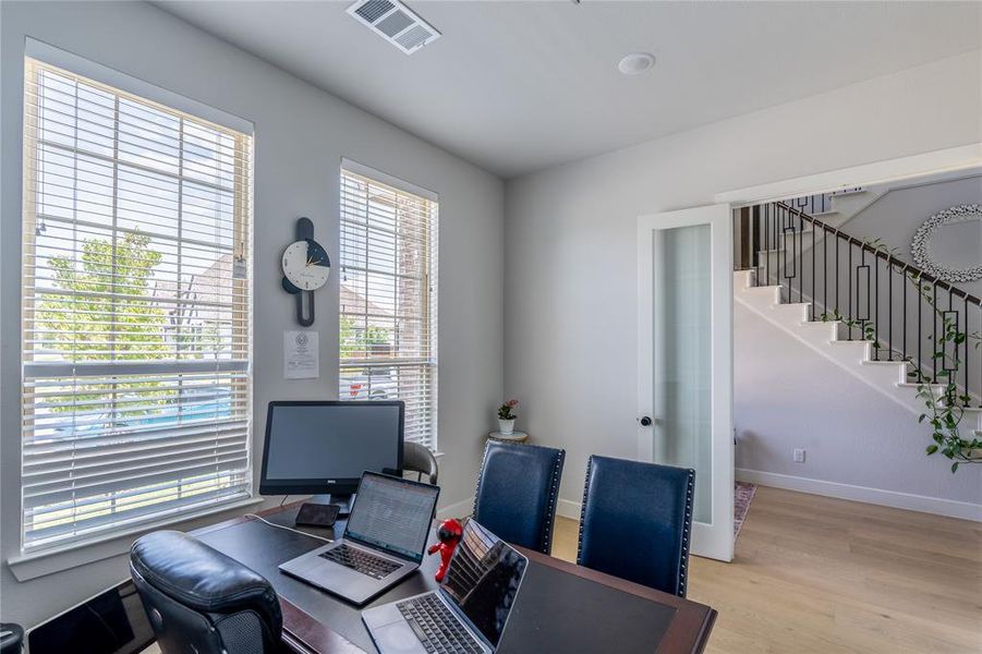 Home office featuring light wood-type flooring and baseboards