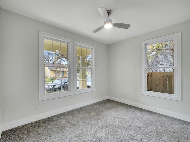 Spare room featuring light colored carpet and a ceiling fan Spare room featuring light colored carpet and a ceiling fan