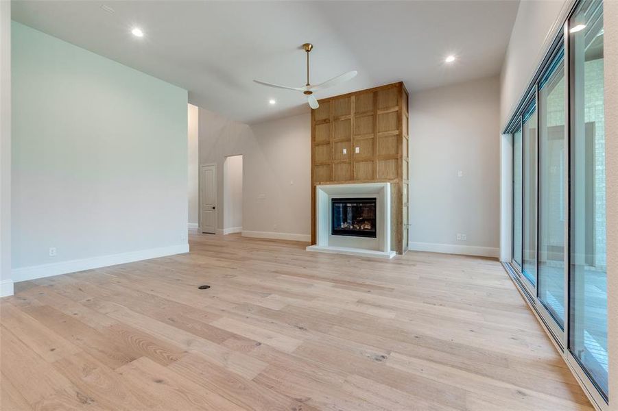 Unfurnished living room with a fireplace, light wood-style flooring, recessed lighting, and ceiling fan Unfurnished living room with a fireplace, light wood-style flooring, recessed lighting, and ceiling fan