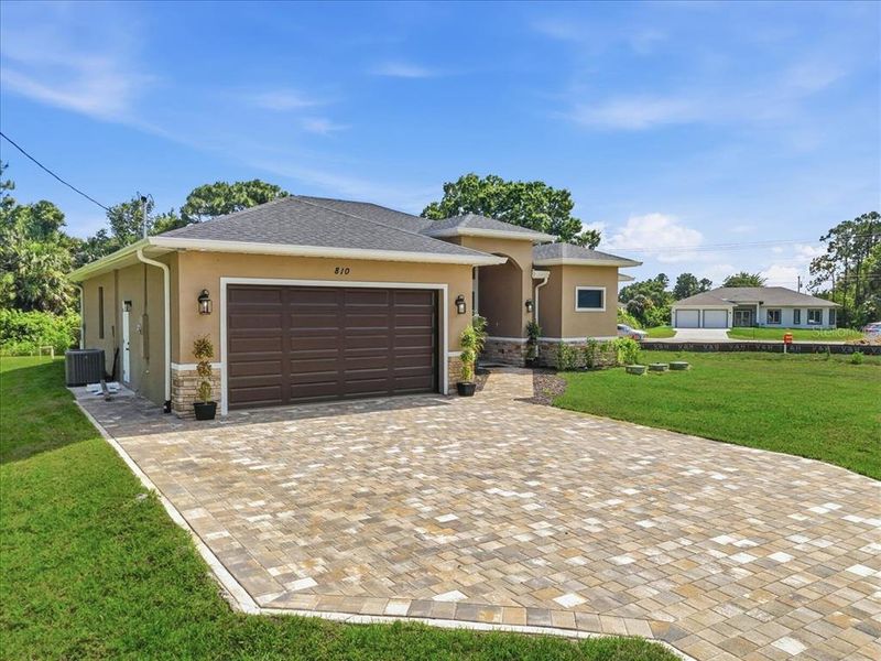 Front exterior of a new home in , Lehigh Acres, FL, highlighting curb appeal (Image 24).