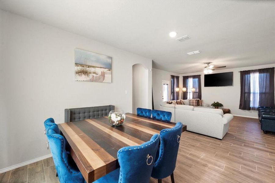 Dining space with light wood-type flooring and ceiling fan