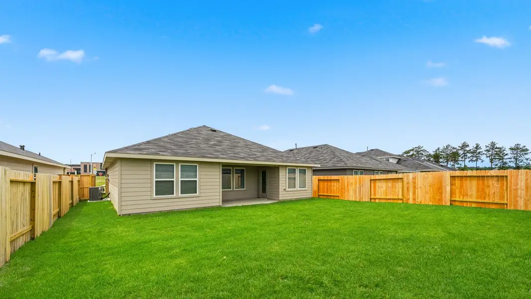 Exterior details and patio area of a home in The Canopies, Splendora (Image 3).