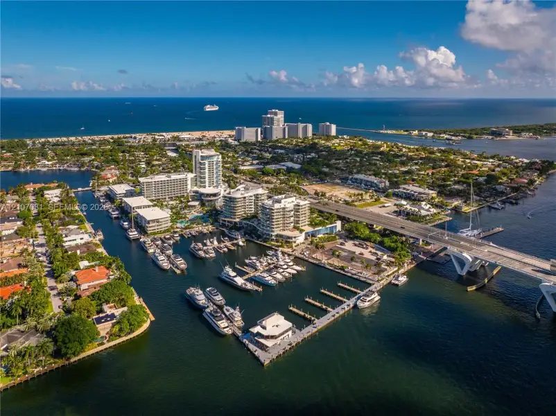 Aerial perspective of a coastal marina featuring deep-water slips, concrete docking infrastructure, and direct access to open water Aerial perspective of a coastal marina featuring deep-water slips, concrete docking infrastructure, and direct access to open water