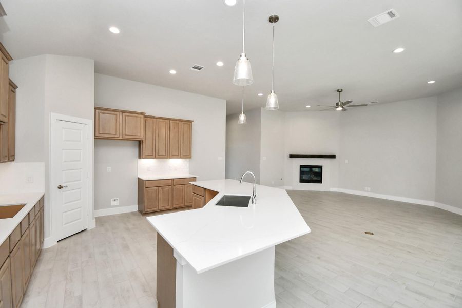 Discover another perspective of this stunning kitchen, generously appointed with an abundance of counter space. Discover another perspective of this stunning kitchen, generously appointed with an abundance of counter space.