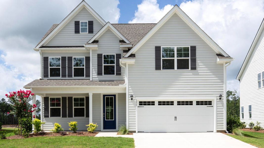 Front exterior of a new home in Indigo Preserve, Leland, NC, highlighting curb appeal (Image 1).