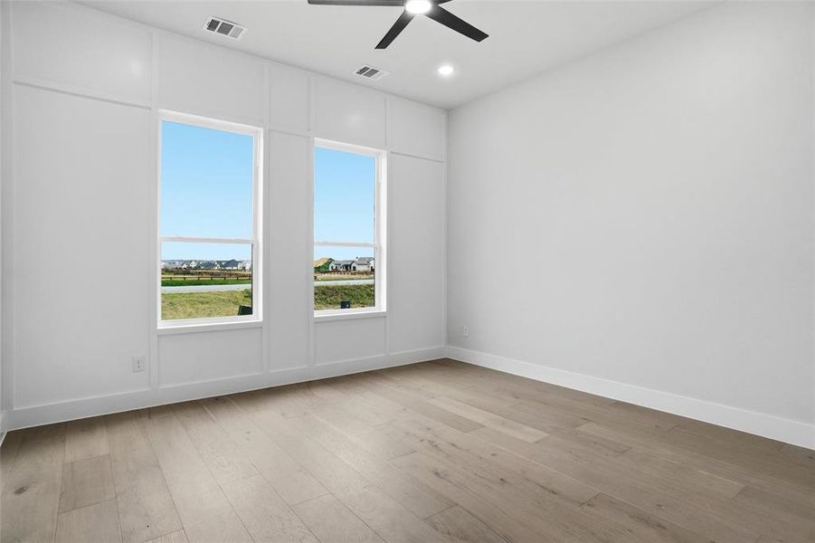 Secondary bedroom featuring a walk-in closet with convenient access to a nearby full bathroom.