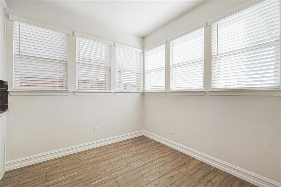 Spare room featuring wood-type flooring