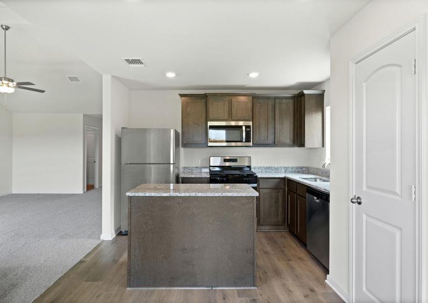 The kitchen has gorgeous wood cabinetry.