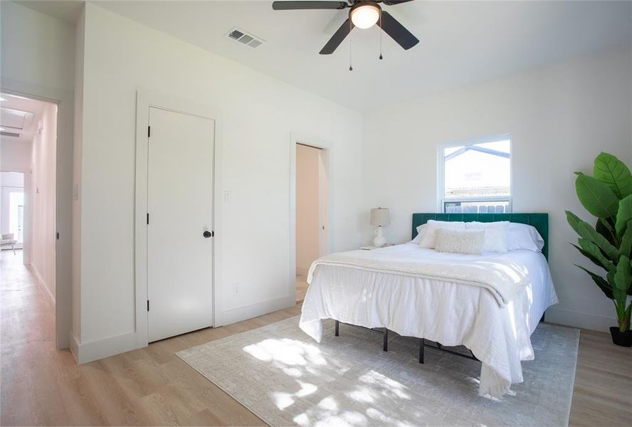 Bedroom featuring ceiling fan and light hardwood / wood-style flooring