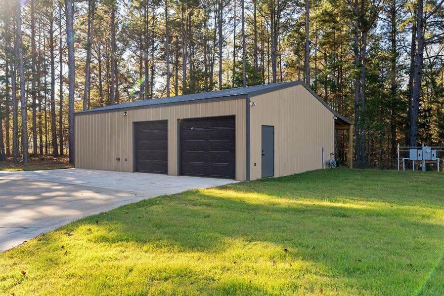 Detached garage with view of scattered trees