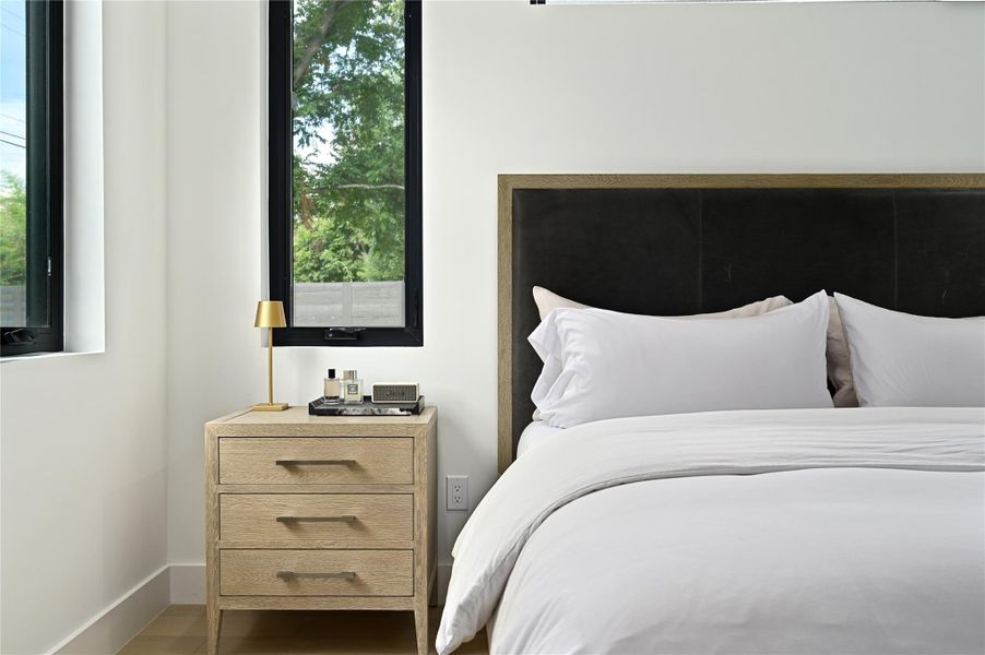 Bedroom featuring wood finished floors and baseboards