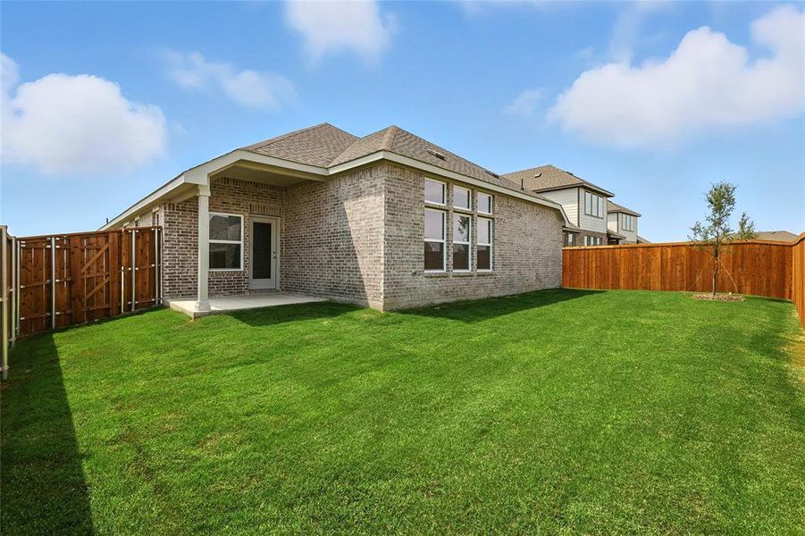 Back of property featuring a patio, a fenced backyard, roof with shingles, and brick siding Back of property featuring a patio, a fenced backyard, roof with shingles, and brick siding