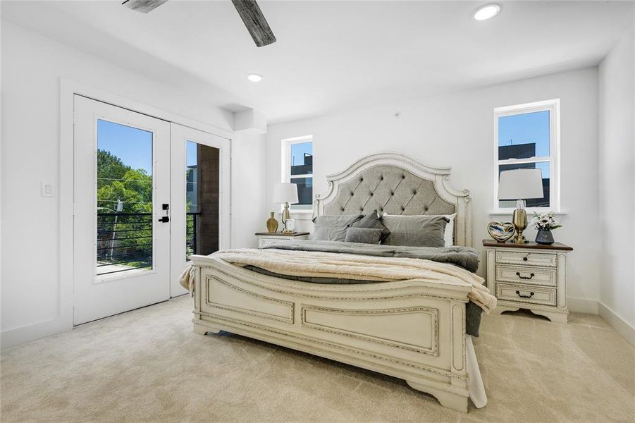 Bedroom with french doors, light carpet, ceiling fan, and access to exterior