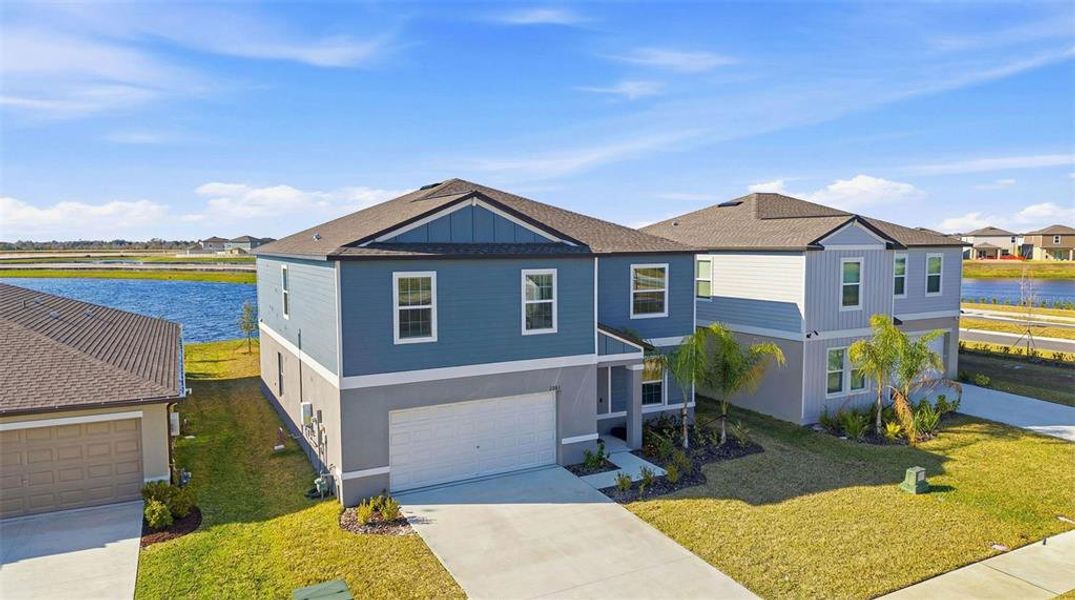 Front exterior of a new home in Prosperity Lakes, Parrish, FL, highlighting curb appeal (Image 27).