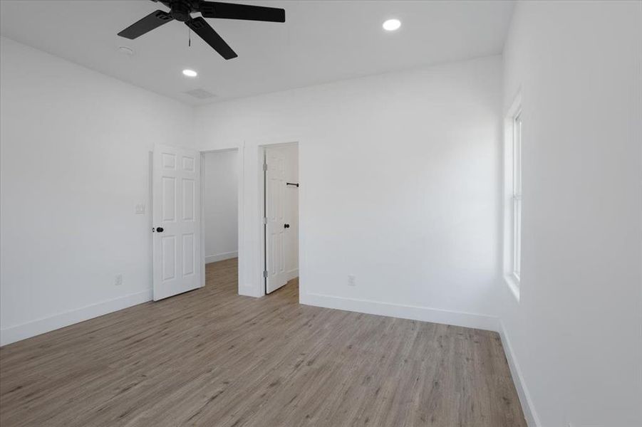 Spare room featuring ceiling fan and light wood-type flooring