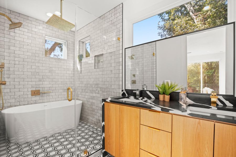 Primary bathroom featuring Japanese -style wet area with tile walls, a freestanding bath, double vanity, and light tile patterned flooring Primary bathroom featuring Japanese -style wet area with tile walls, a freestanding bath, double vanity, and light tile patterned flooring