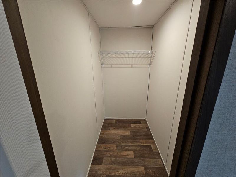 Walk in closet with dark wood-type flooring Walk in closet with dark wood-type flooring