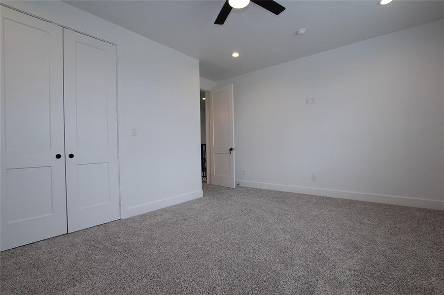 Unfurnished bedroom with carpet floors, a closet, recessed lighting, and ceiling fan Unfurnished bedroom with carpet floors, a closet, recessed lighting, and ceiling fan