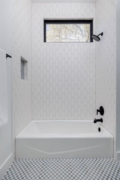 The bathroom features a clean, modern design with stone surfaces, custom cabinetry, and elevated tile selections. The bathroom features a clean, modern design with stone surfaces, custom cabinetry, and elevated tile selections.