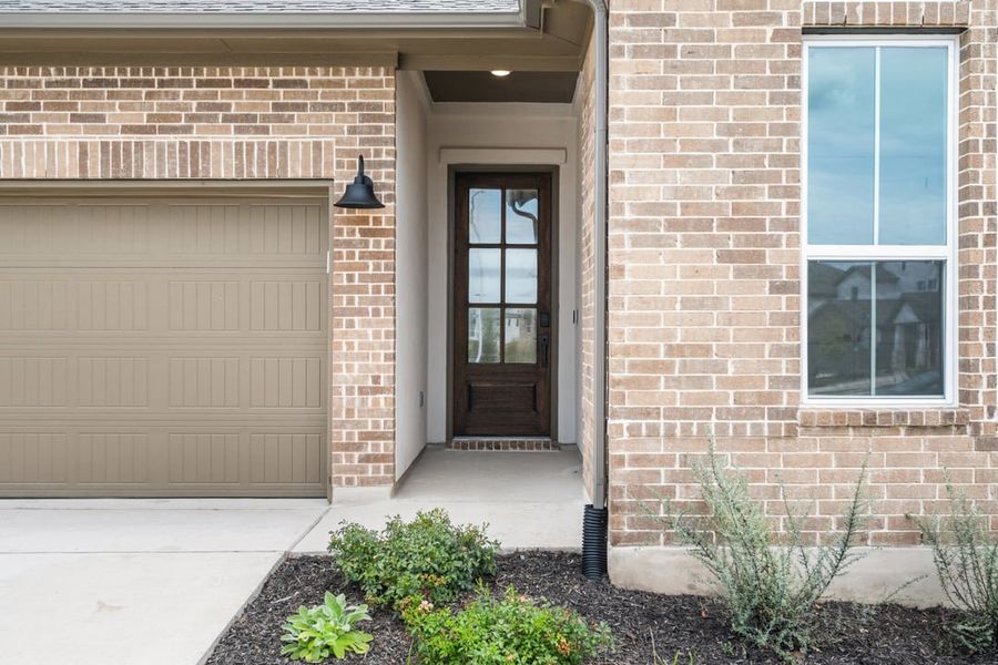 Front exterior of a new home in Arbor Collection at Lariat, Liberty Hill, TX, highlighting curb appeal (Image 25). Front exterior of a new home in Arbor Collection at Lariat, Liberty Hill, TX, highlighting curb appeal (Image 25).