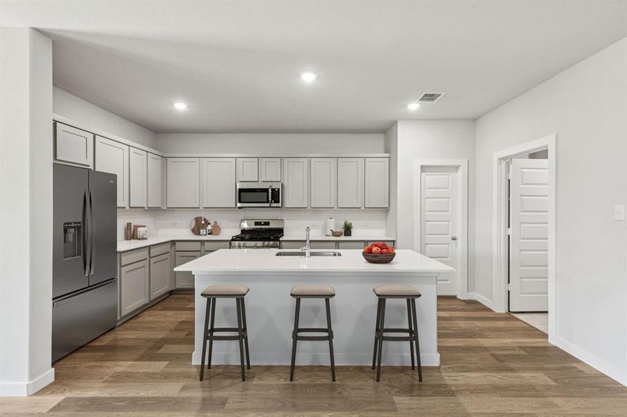 Kitchen in the Oscar home plan by Trophy Signature Homes – REPRESENTATIVE PHOTO