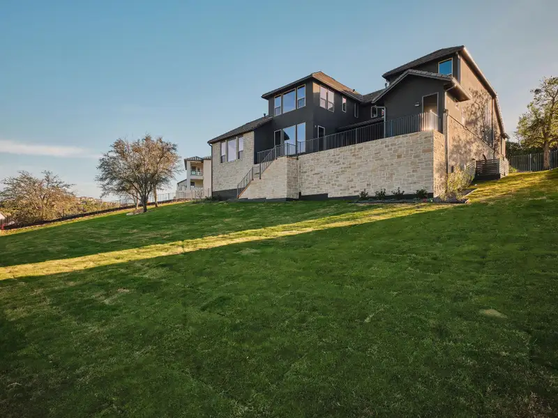 The exterior is complete with a durable concrete tile roof and prepping for a future pool.