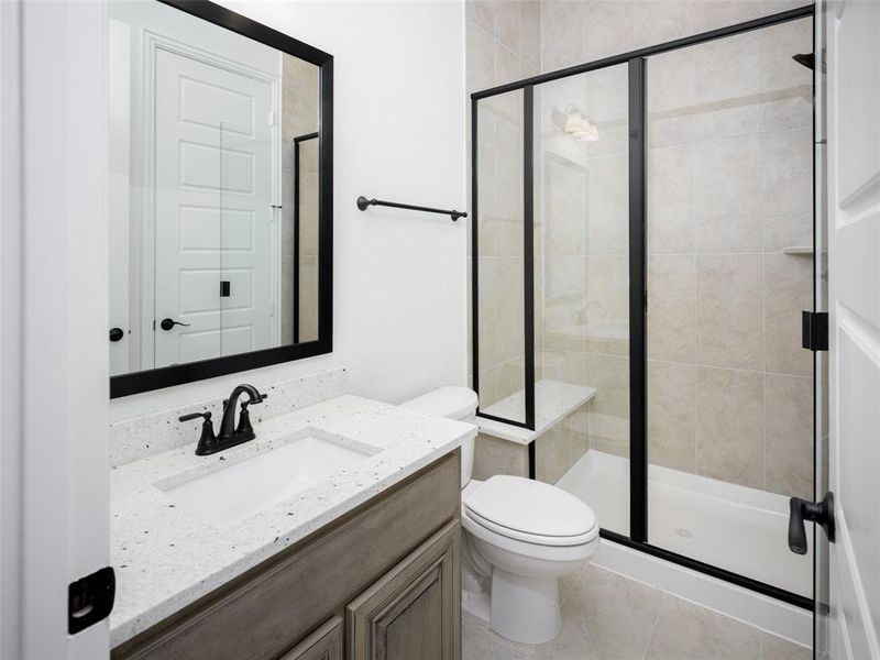 Full bath featuring vanity, a shower stall, and tile patterned floors Full bath featuring vanity, a shower stall, and tile patterned floors
