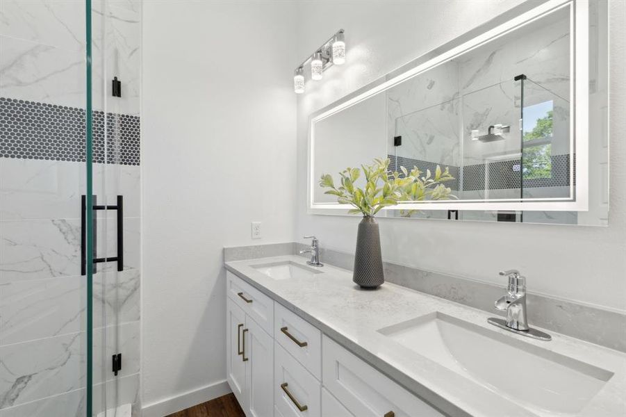 Full bathroom featuring a large vanity with dual sinks Full bathroom featuring a large vanity with dual sinks