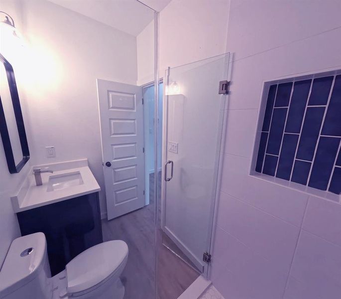 Full bath featuring vanity and a shower stall Full bath featuring vanity and a shower stall