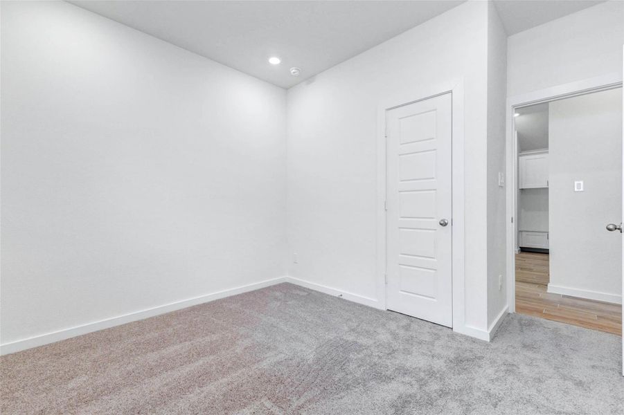 Comfortable secondary bedroom with plush carpet, neutral walls, recessed lighting, and a closet for storage. This flexible room is ideal for a guest bedroom, child’s room, home office, hobby space, or additional living needs.