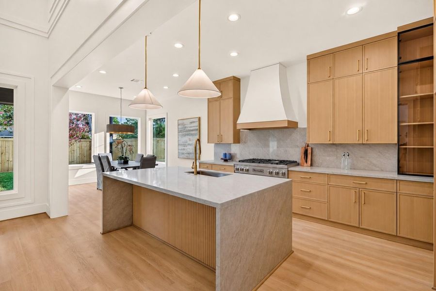 The designer kitchen is beautifully appointed with premium finishes, custom cabinetry, high-end appliances will be included, and an oversized waterfall island perfect for everyday living. The designer kitchen is beautifully appointed with premium finishes, custom cabinetry, high-end appliances will be included, and an oversized waterfall island perfect for everyday living.