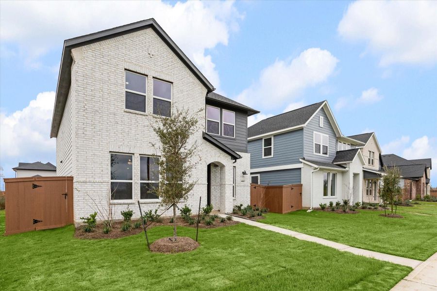 Front exterior of a new home in Elyson, Katy, TX, highlighting curb appeal (Image 20).