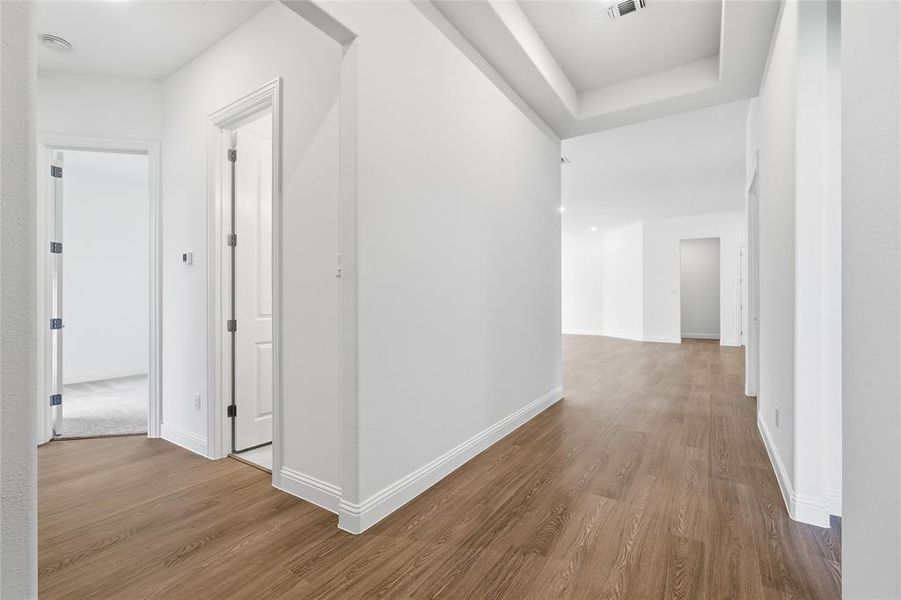 Hallway with wood finished floors and baseboards