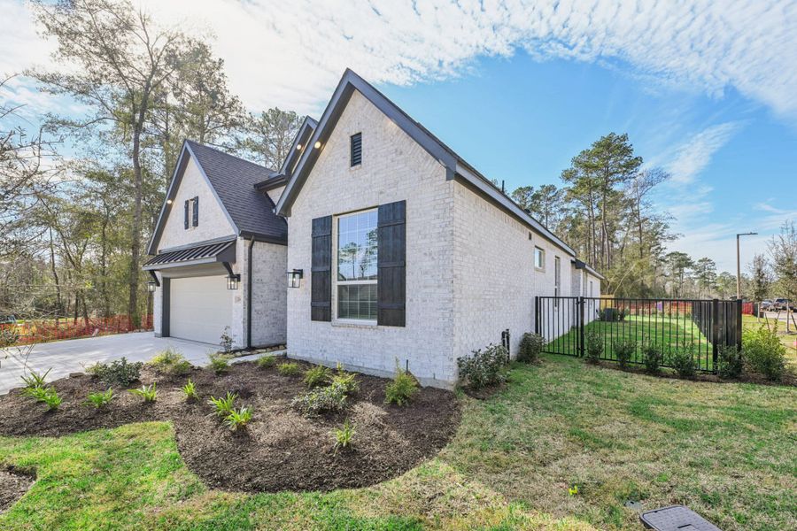 Front exterior of a new home in The Woodlands Hills, Willis, TX, highlighting curb appeal (Image 23).