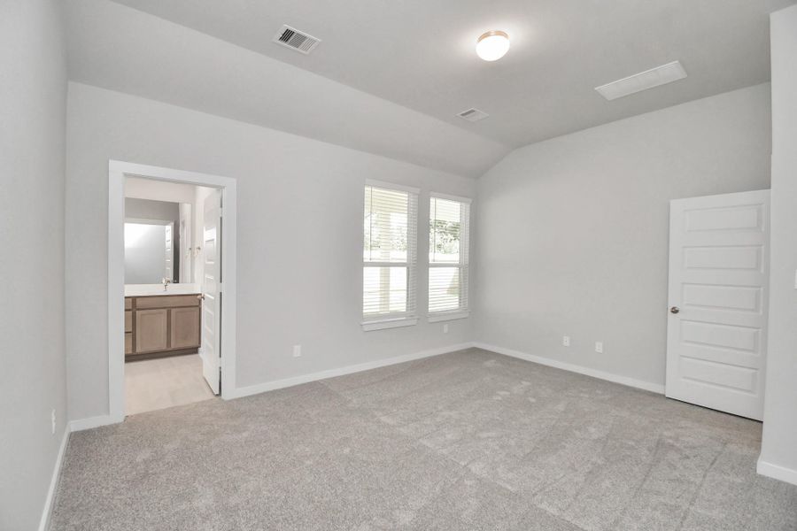 Escape and relax in the exquisite primary suite, a haven to unwind after a long day. The spacious room, boasts plush carpeting, soothing paint tones, high ceilings, and expansive windows adorned with privacy blinds. Sample photo of completed home with similar floor plan. Actual colors and selections may vary. Escape and relax in the exquisite primary suite, a haven to unwind after a long day. The spacious room, boasts plush carpeting, soothing paint tones, high ceilings, and expansive windows adorned with privacy blinds. Sample photo of completed home with similar floor plan. Actual colors and selections may vary.