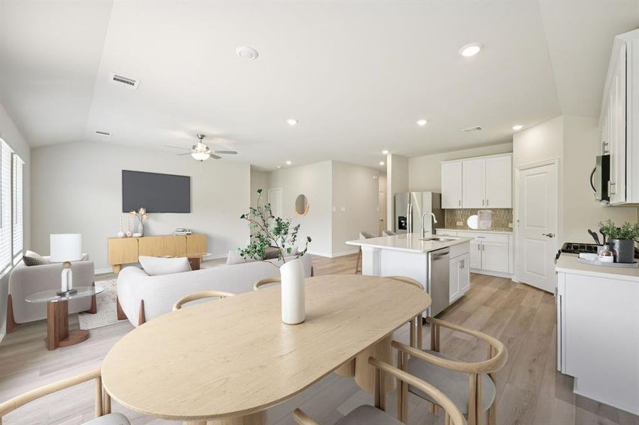 Dining room with light wood-type flooring, a ceiling fan, and recessed lighting