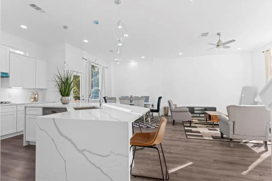 Open-concept layout combining the kitchen, dining, and living areas for seamless entertaining.